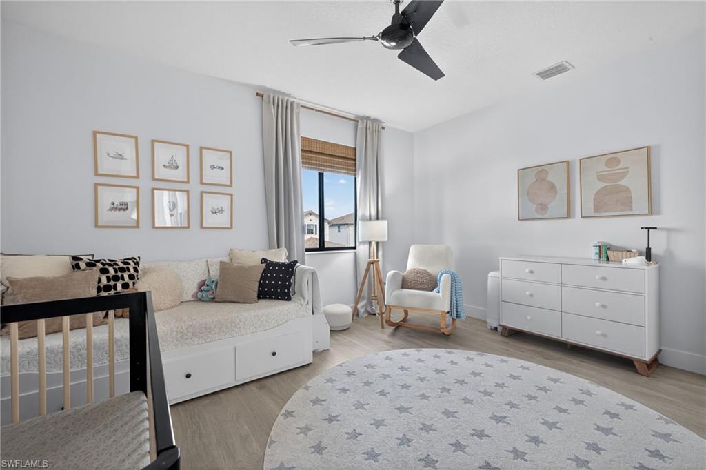 Bedroom featuring light wood-style flooring and a ceiling fan