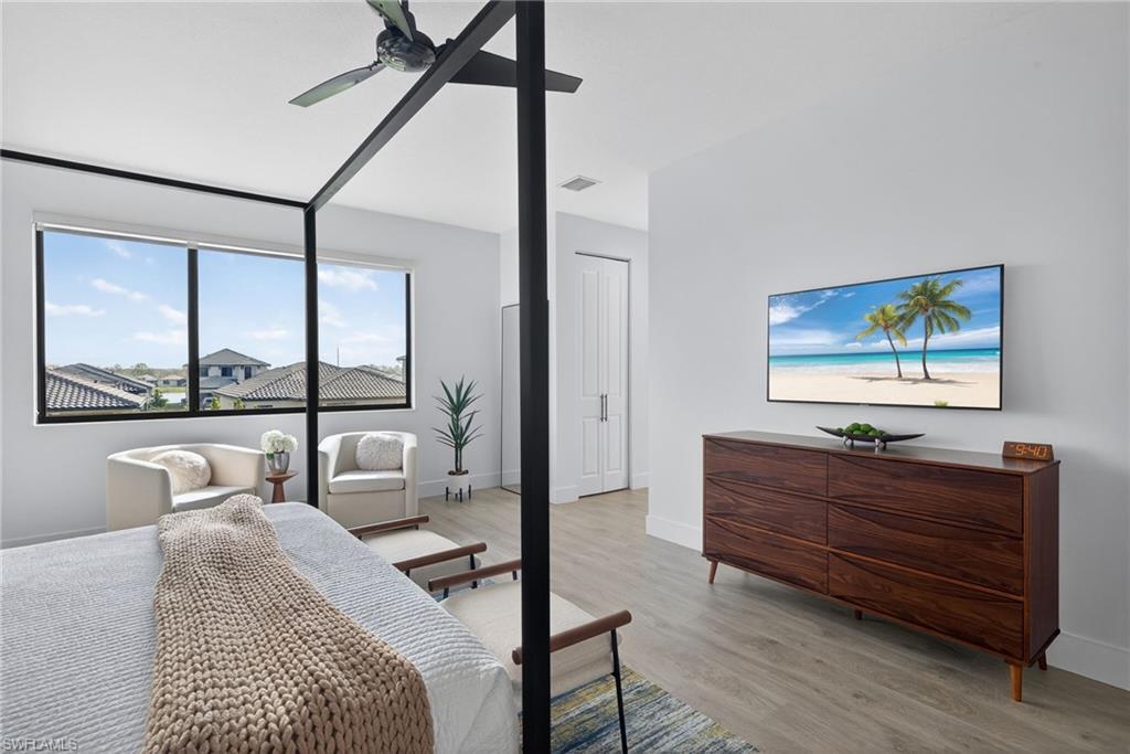 Bedroom with light wood-style flooring and a ceiling fan