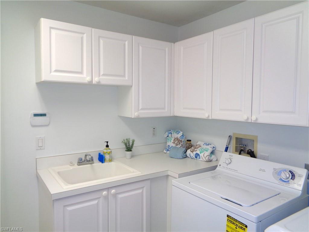 Laundry room featuring washer / clothes dryer and cabinet space