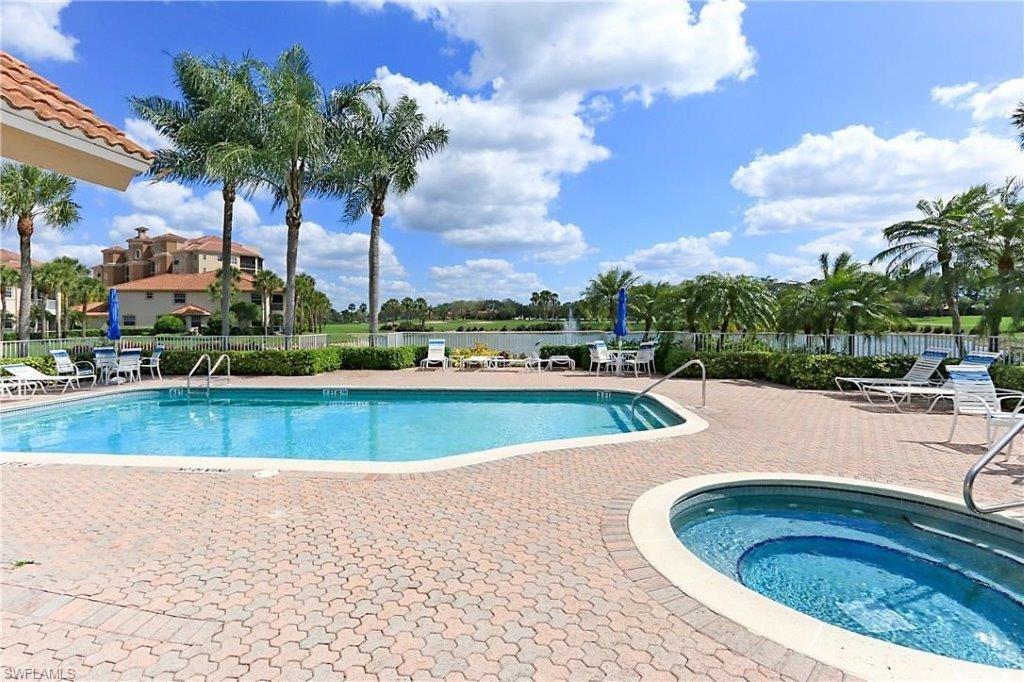 Community pool with a patio and a hot tub