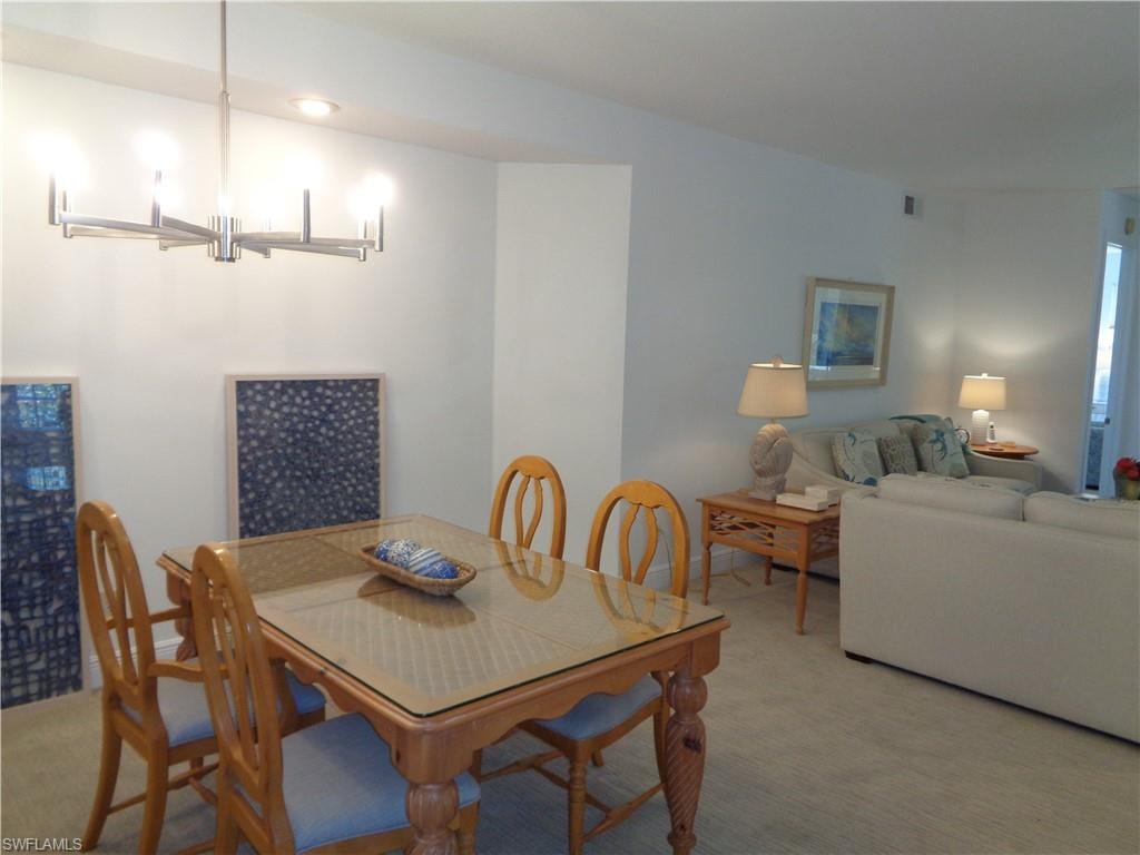 Dining room with light colored carpet