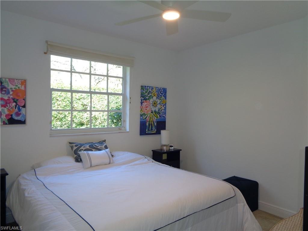 Bedroom featuring ceiling fan and baseboards
