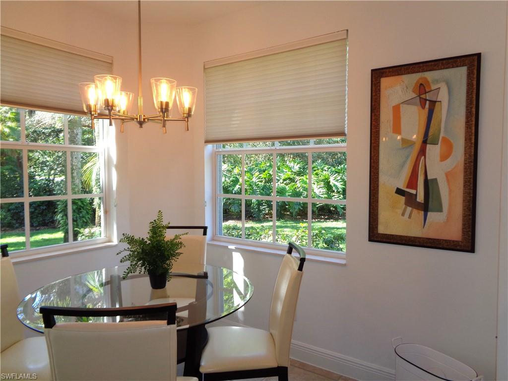 Dining area with a chandelier and baseboards