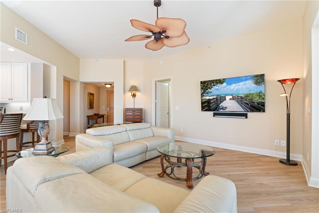 Living area with light wood-type flooring and a ceiling fan