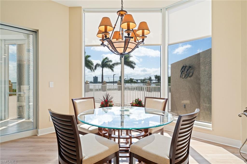 Dining room featuring hanging lights, plenty of natural light, and light wood-type flooring