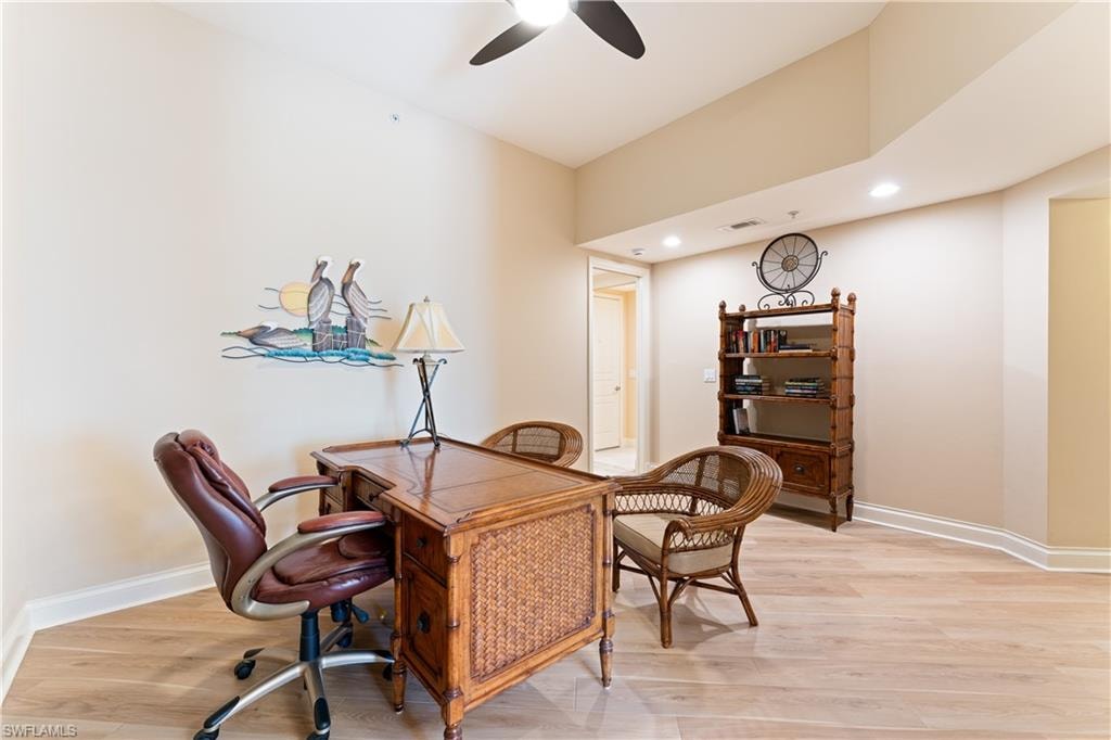 Office space featuring recessed lighting, light wood-style flooring, and a ceiling fan