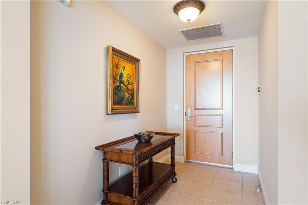 Doorway to outside with tile patterned floors and baseboards
