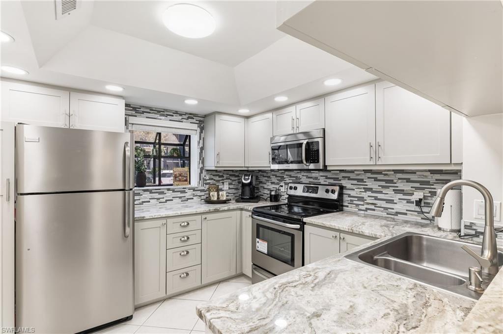 Updated kitchen with granite & custom backsplash