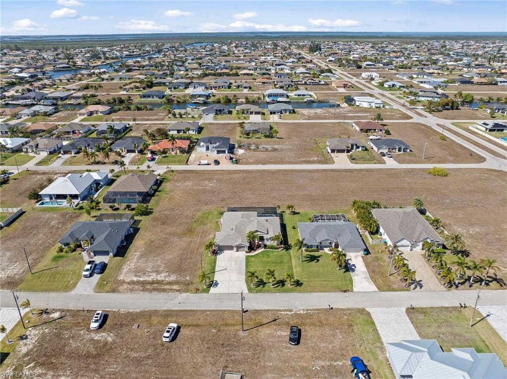 Aerial view of property's location featuring nearby suburban area