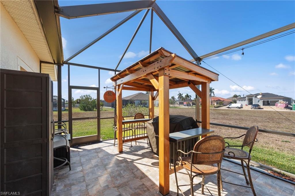 View of patio / terrace with a lanai, a sunroom, and a residential view