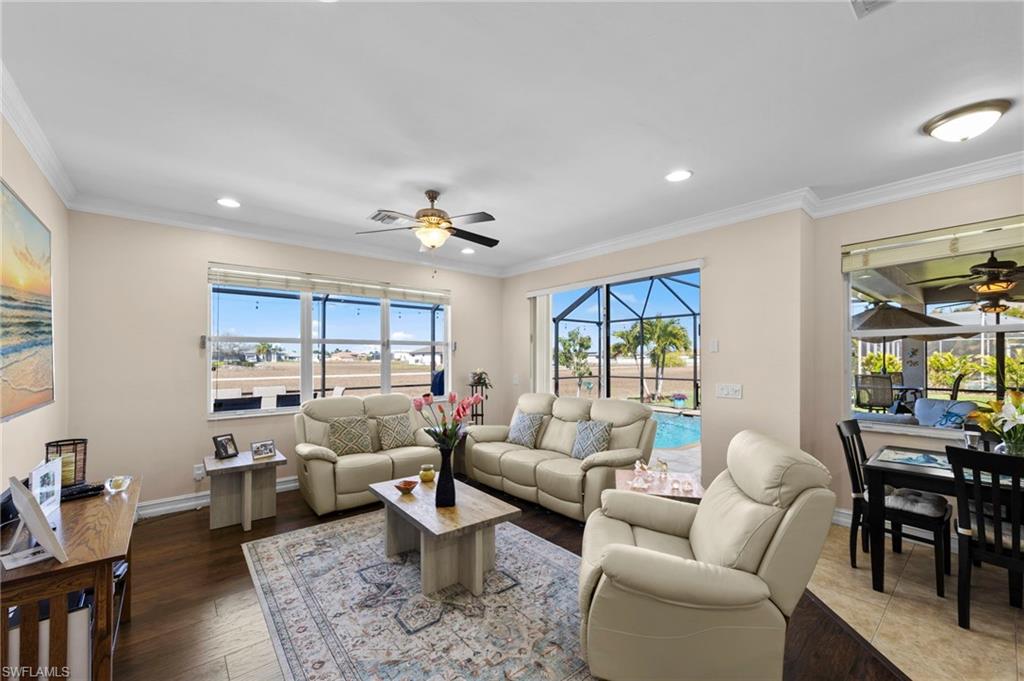 Living room with ceiling fan, crown molding, a sunroom, recessed lighting, and wood finished floors