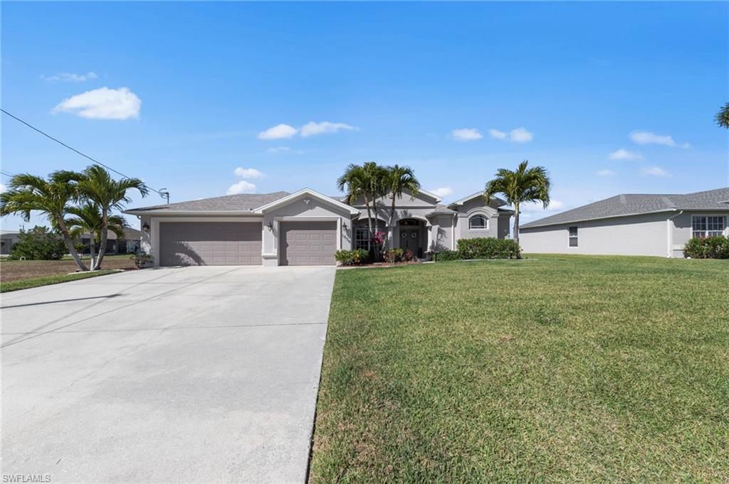 Single story home featuring a garage, a front yard, and concrete driveway
