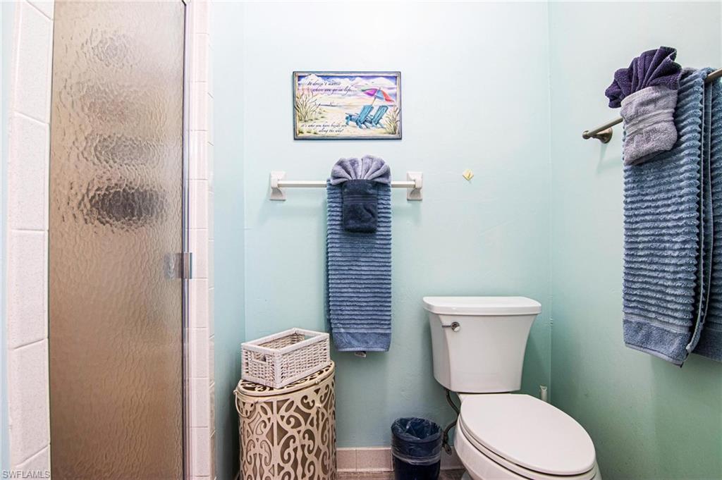 Full bathroom with toilet and a shower stall