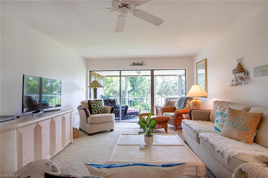 Living room with ceiling fan and carpet floors