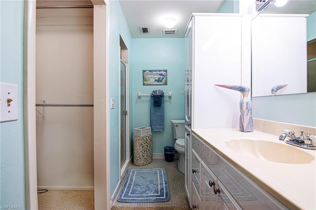 Full bathroom with vanity and a stall shower