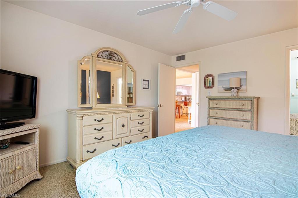 Bedroom with light carpet and a ceiling fan