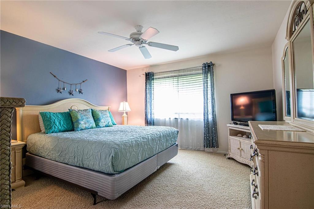 Bedroom featuring light carpet and a ceiling fan