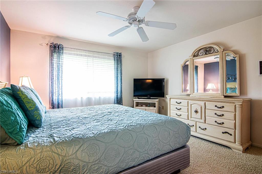 Bedroom featuring light carpet and ceiling fan
