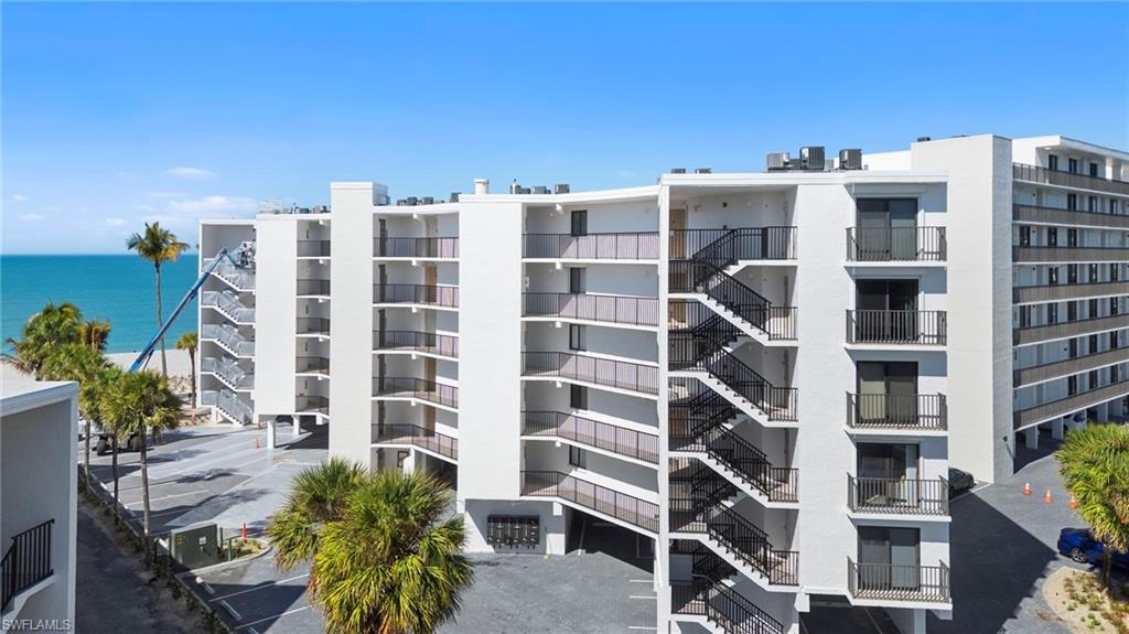 View of apartment building / complex featuring a water view