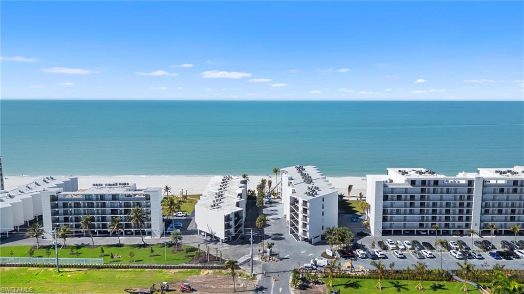 Drone / aerial view of apartment complex and expansive coastline