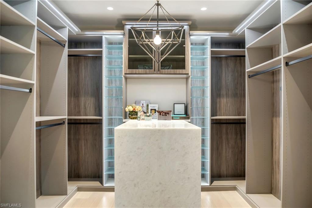 Her primary closet with Quartz waterfall island