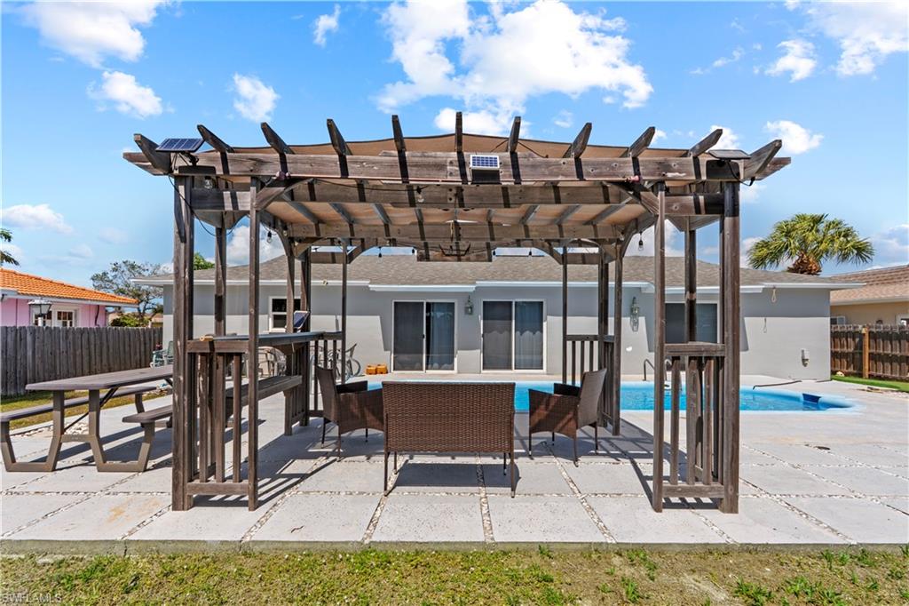 View of patio with outdoor furniture and a pergola