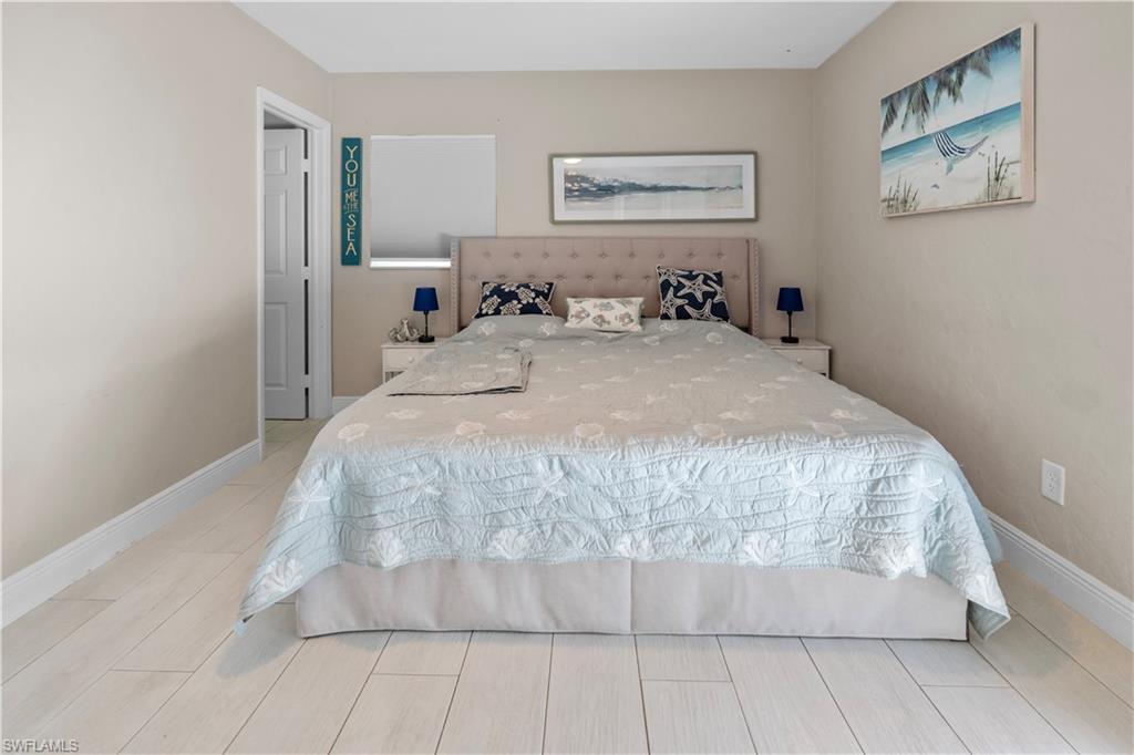 Bedroom featuring baseboards and wood finish floors