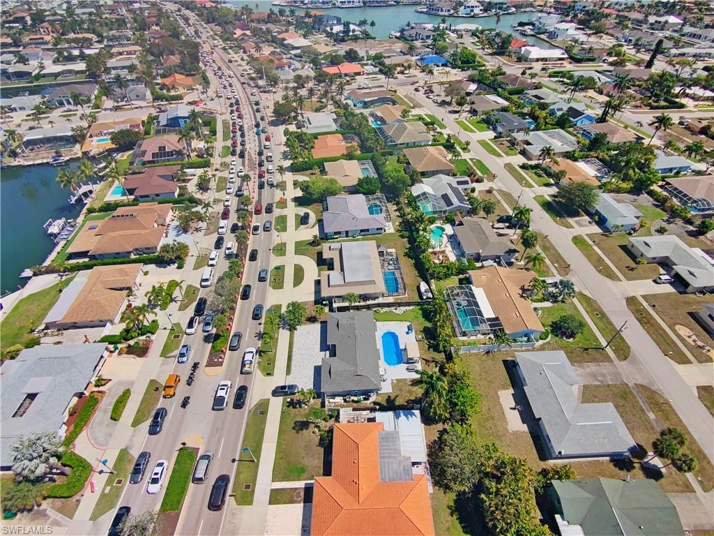Aerial overview of property's location with nearby suburban area and a nearby body of water