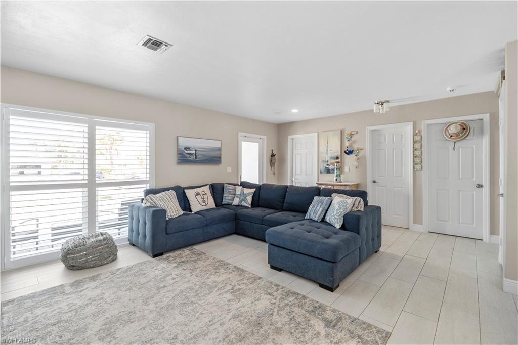 Living room with healthy amount of natural light and recessed lighting
