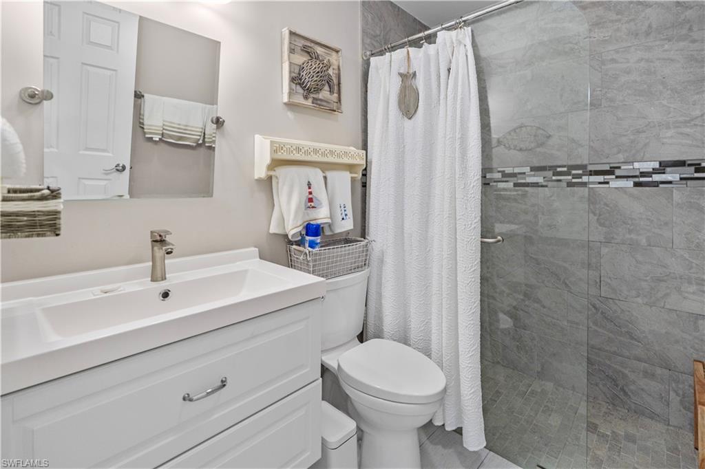Full bathroom featuring a shower stall and vanity