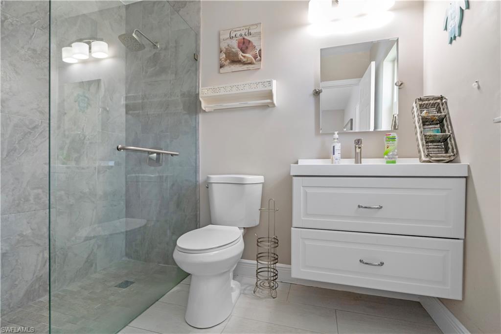 Full bathroom with vanity, a walk in shower, and light tile patterned floors