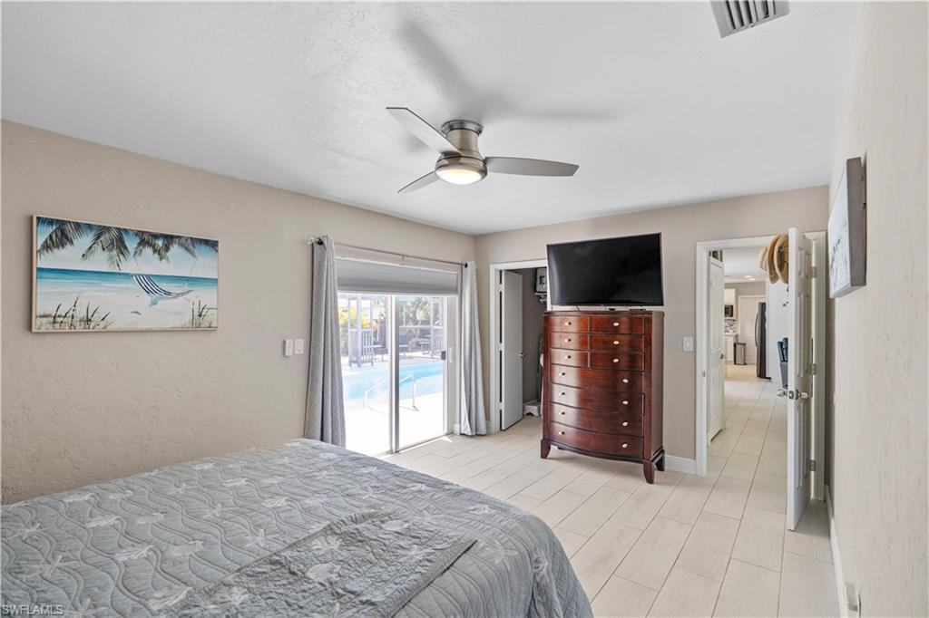 Bedroom featuring ceiling fan, access to outside, and wood tiled floors