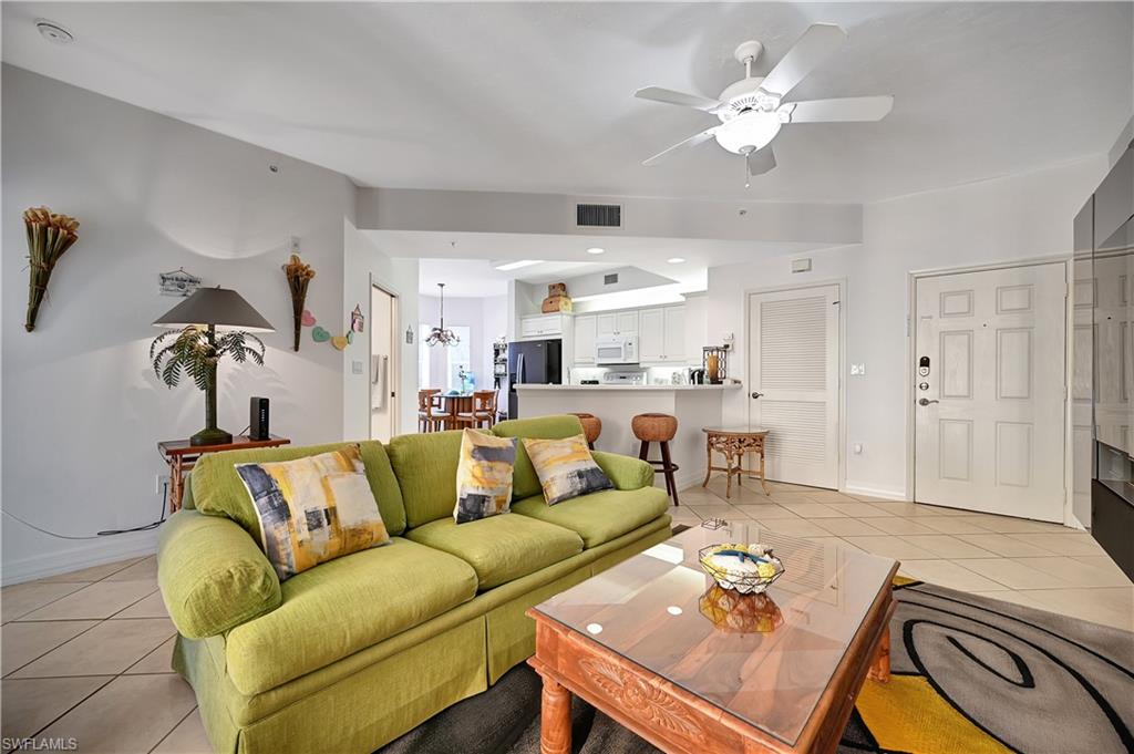 Living room featuring light tile patterned flooring and ceiling fan