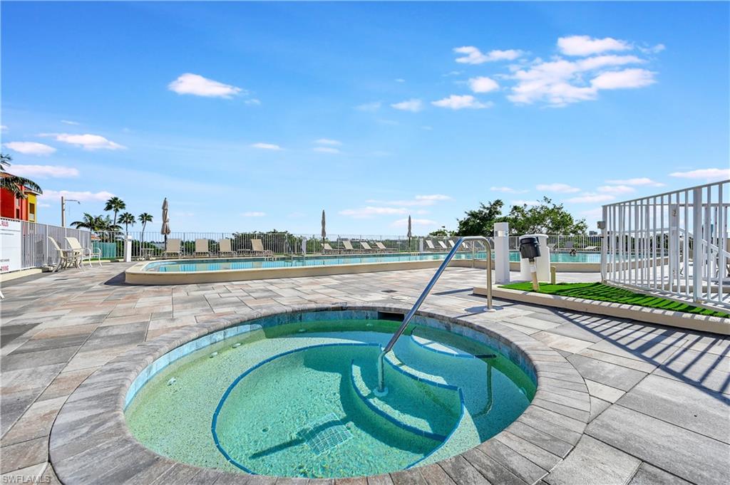 Community pool with a community hot tub and a patio
