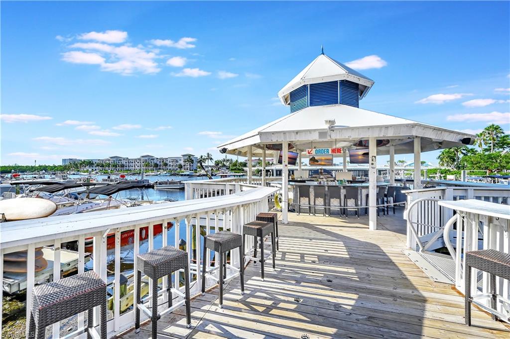Dock area featuring a deck with water view, exterior bar, and a gazebo