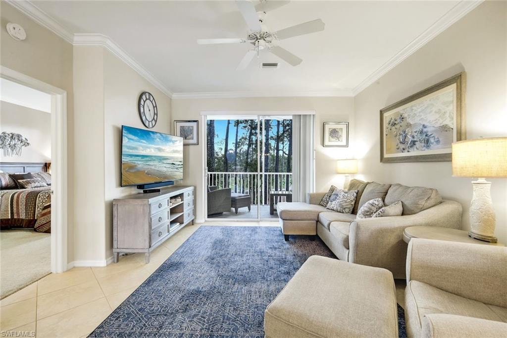 Living area featuring crown molding, ceiling fan, and light tile patterned flooring