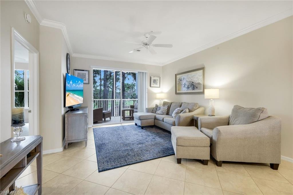 Living area featuring a ceiling fan, ornamental molding, healthy amount of natural light, and light tile patterned flooring
