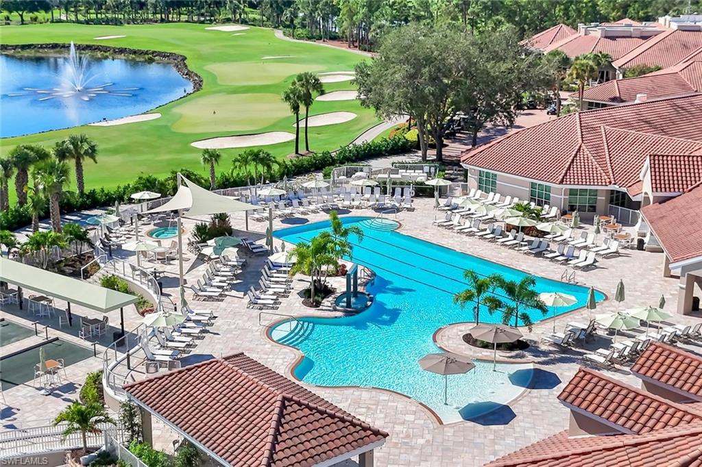 Community pool featuring a water view, golf course view, and a patio area