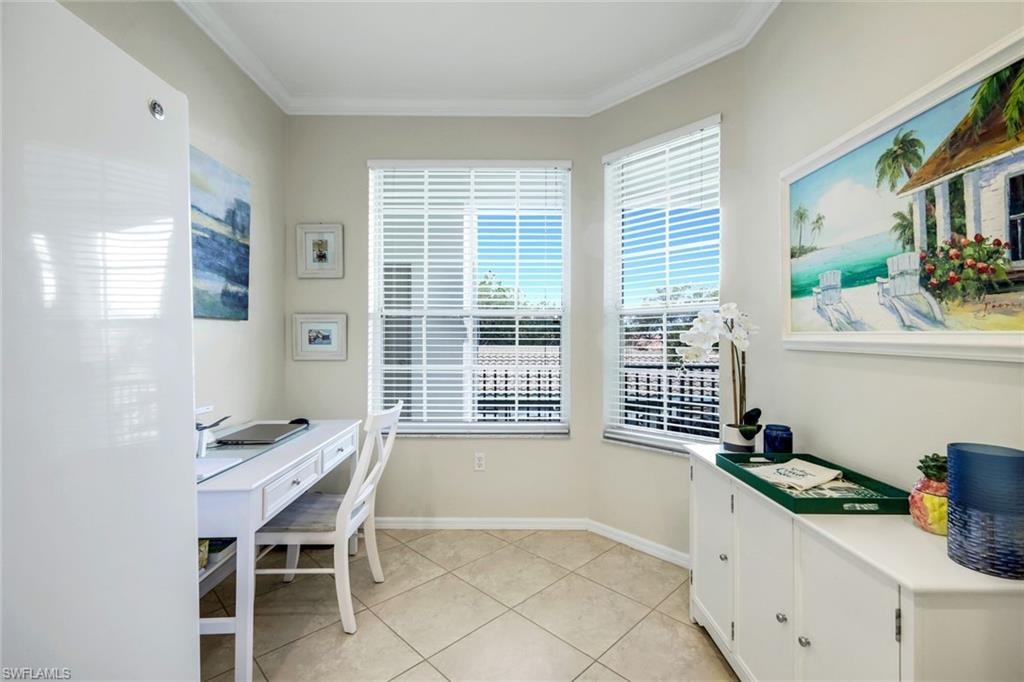 Office area with crown molding and light tile patterned floors