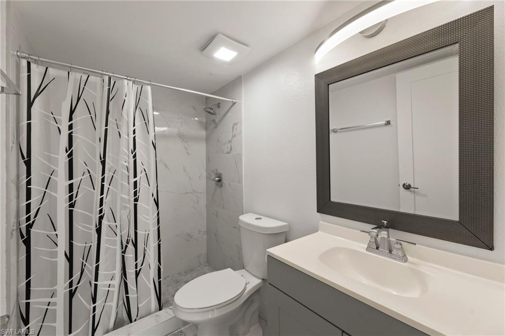 Full bathroom featuring a shower stall and vanity