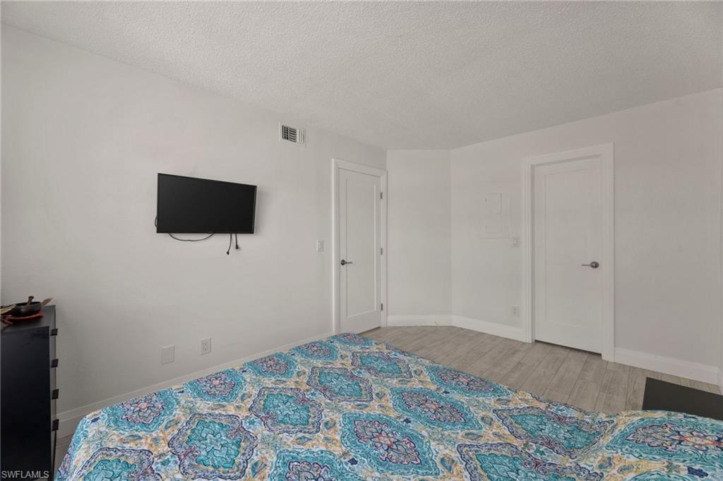 Bedroom featuring light wood-style flooring and a textured ceiling