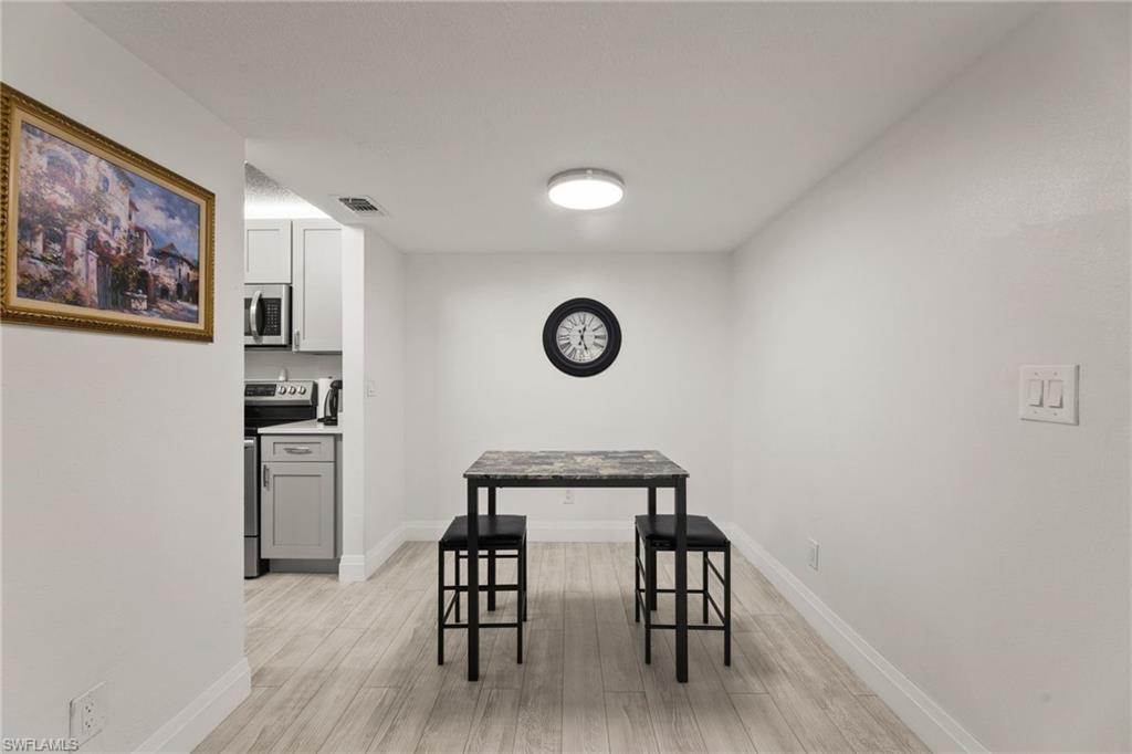 Dining space featuring light wood-type flooring and baseboards