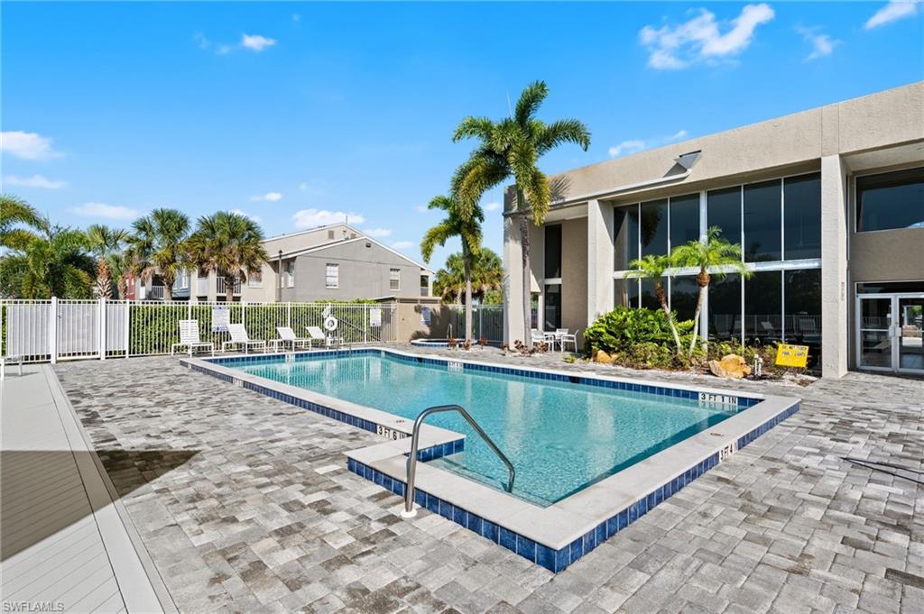 Community pool with a patio