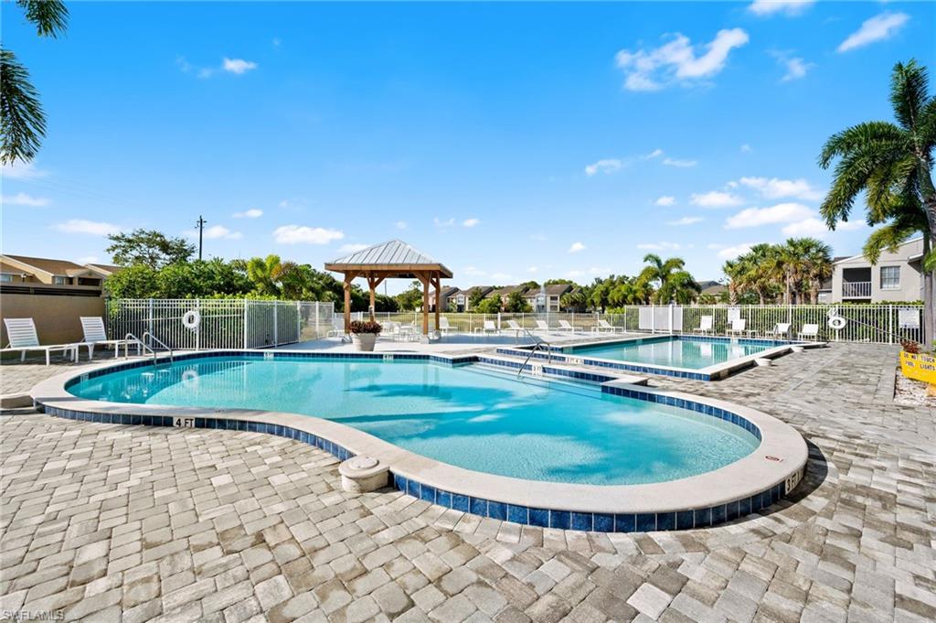 Community pool with a patio area and a gazebo