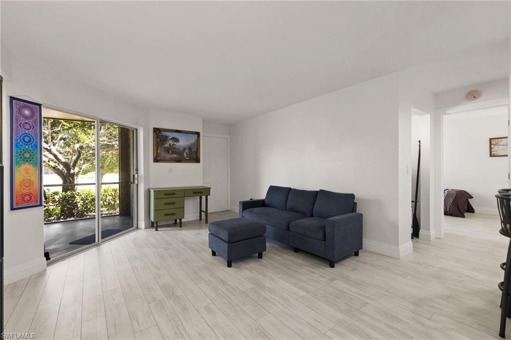 Living area with light wood-style floors and baseboards