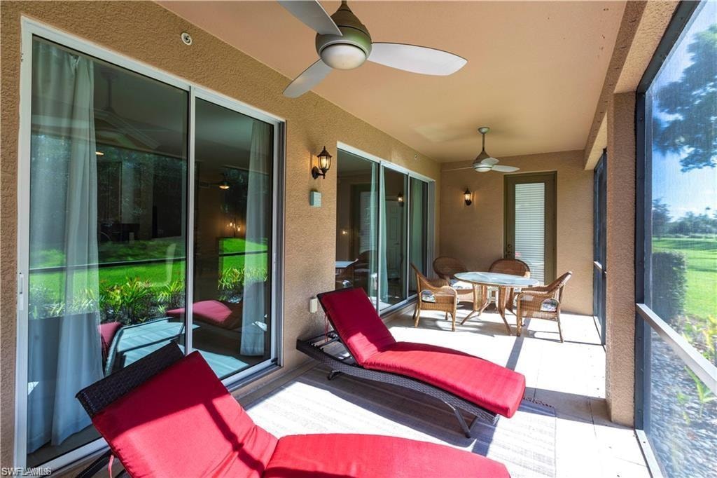 Sunroom / solarium featuring a textured wall and plenty of natural light