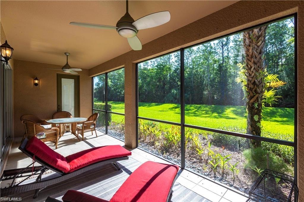 Sunroom featuring ceiling fan and outdoor dining area