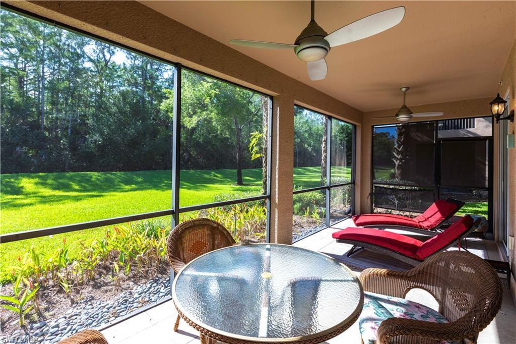 Sunroom with a ceiling fan and outdoor dining area