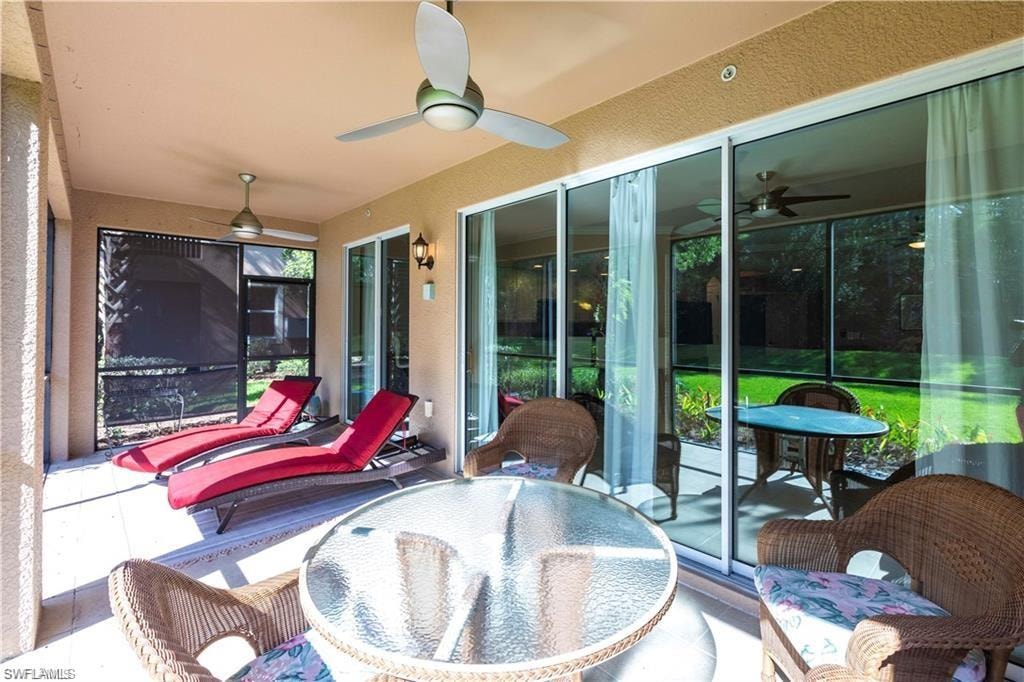 Sunroom featuring a ceiling fan and outdoor dining space