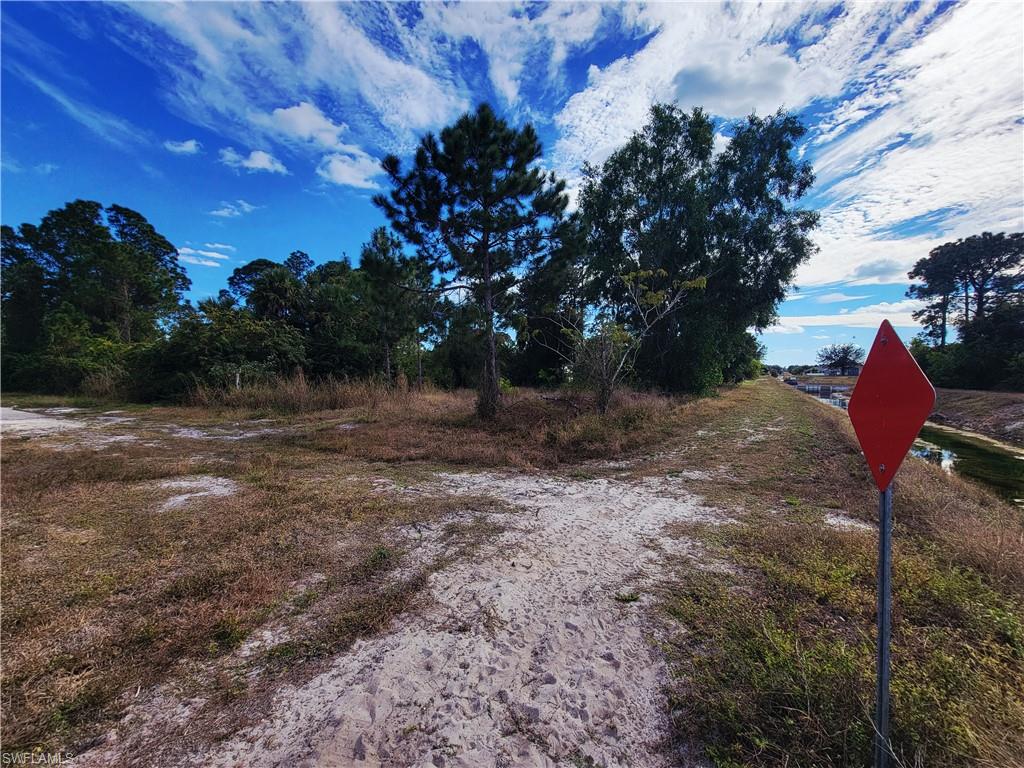 View of dirt / gravel road featuring traffic signs